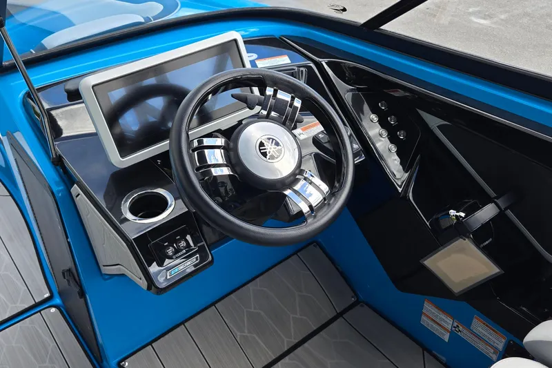Slide: The Image of 2022 Yamaha Boats 255XD dashboard with steering wheel and touchscreen display. - 7