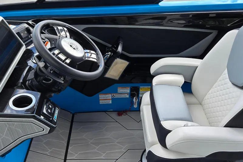 Slide: The Image of Interior of 2022 Yamaha Boats 255XD, featuring steering wheel and luxurious captain's chair. - 8