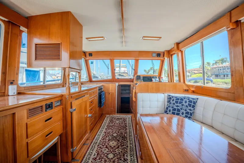 Slide: The Image of Interior of 1998 Grand Banks 43 Eastbay EX yacht with wood finish and seating area. - 11