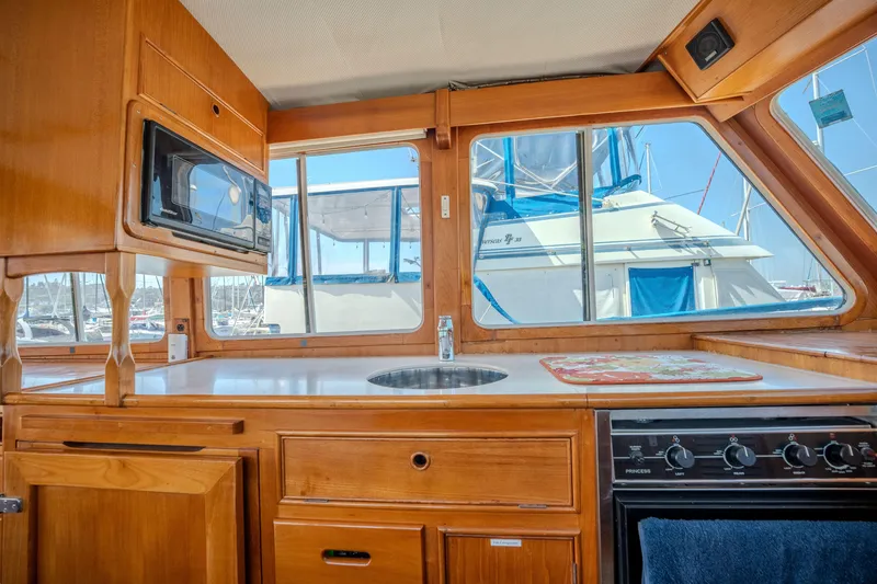Slide: The Image of Interior of 1998 Grand Banks 43 Eastbay EX yacht kitchen with wood cabinetry and appliances. - 14
