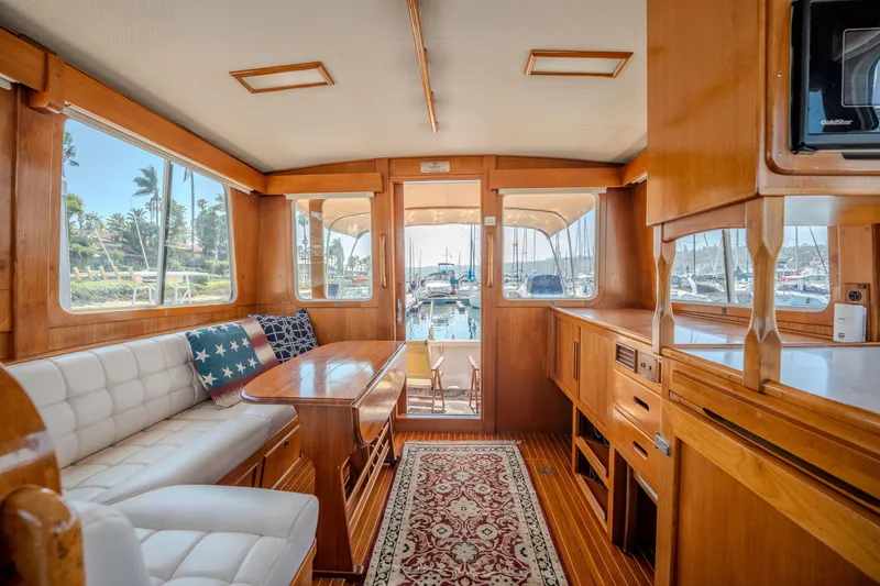 Slide: The Image of Interior of 1998 Grand Banks 43 Eastbay EX yacht with wood finish and marina view. - 15