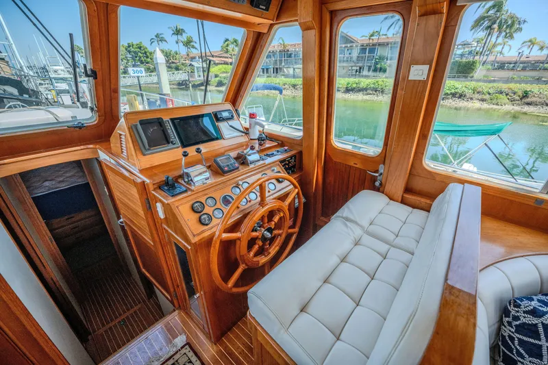 Slide: The Image of 1998 Grand Banks 43 Eastbay EX helm with wooden steering wheel and navigation instruments. - 16