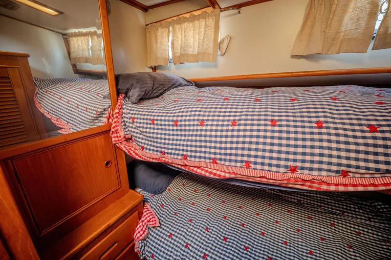Slide: The Image of Cozy cabin bunk beds with checkered bedding on 1998 Grand Banks 43 Eastbay EX yacht. - 18