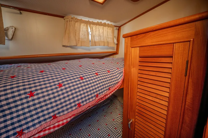 Slide: The Image of Cozy cabin interior of 1998 Grand Banks 43 Eastbay EX with checkered bedding. - 19