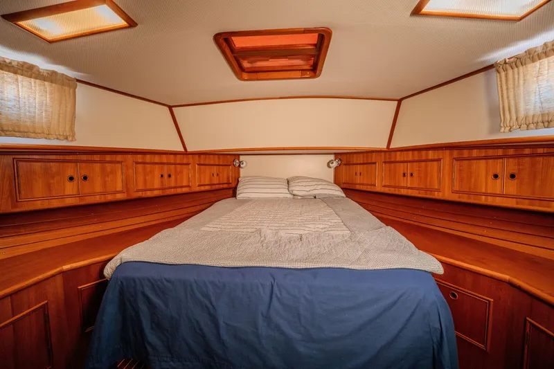 Slide: The Image of Cozy cabin interior of 1998 Grand Banks 43 Eastbay EX with wooden cabinetry and bed. - 21