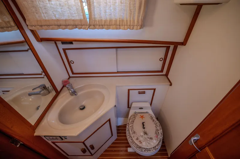 Slide: The Image of Bathroom interior of 1998 Grand Banks 43 Eastbay EX yacht with sink and decorative toilet seat. - 26