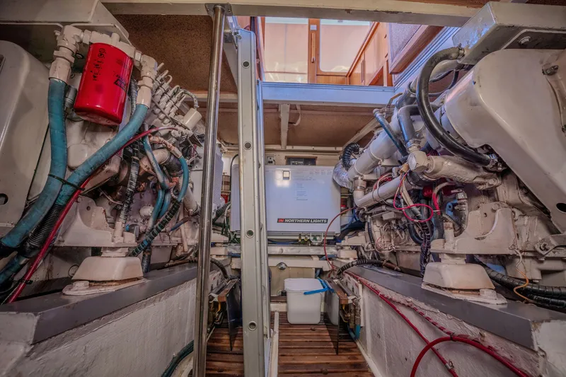 Slide: The Image of Engine room of a 1998 Grand Banks 43 Eastbay EX yacht, showcasing mechanical components. - 27