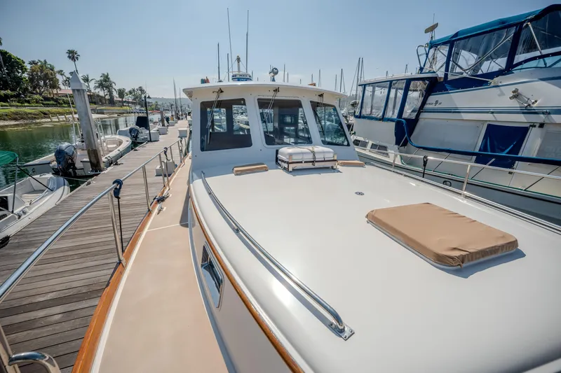 Slide: The Image of 1998 Grand Banks 43 Eastbay EX yacht docked at marina, sunny day. - 30