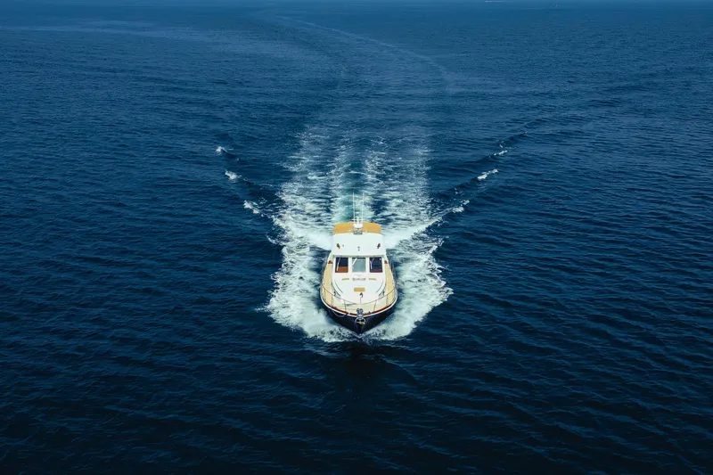 Slide: The Image of 1998 Grand Banks 43 Eastbay EX cruising on open blue sea. - 5