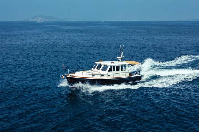 Slide: The Image of 1998 Grand Banks 43 Eastbay EX cruising on open blue sea. - 7