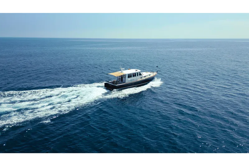 Slide: The Image of 1998 Grand Banks 43 Eastbay EX cruising on open sea under clear skies. - 8