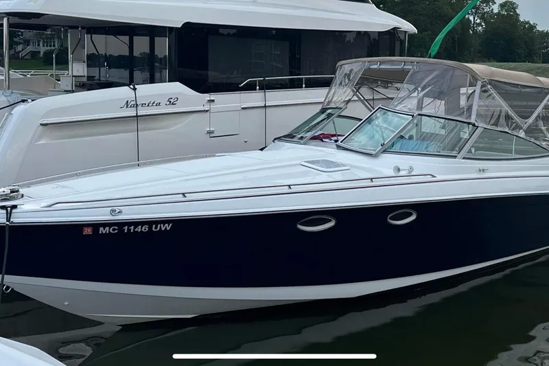 The Image of 1999 Formula 330 Sun Sport boat docked beside Navetta 52 yacht. - 0