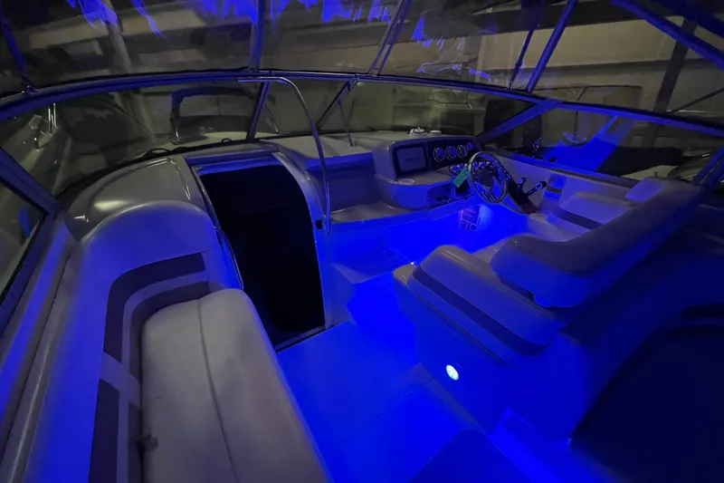 Slide: The Image of 1999 Formula 330 Sun Sport boat interior with open storage and seating area. - 10