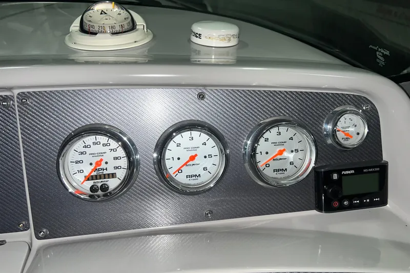 Slide: The Image of 1999 Formula 330 Sun Sport boat dashboard with gauges and steering wheel. - 14
