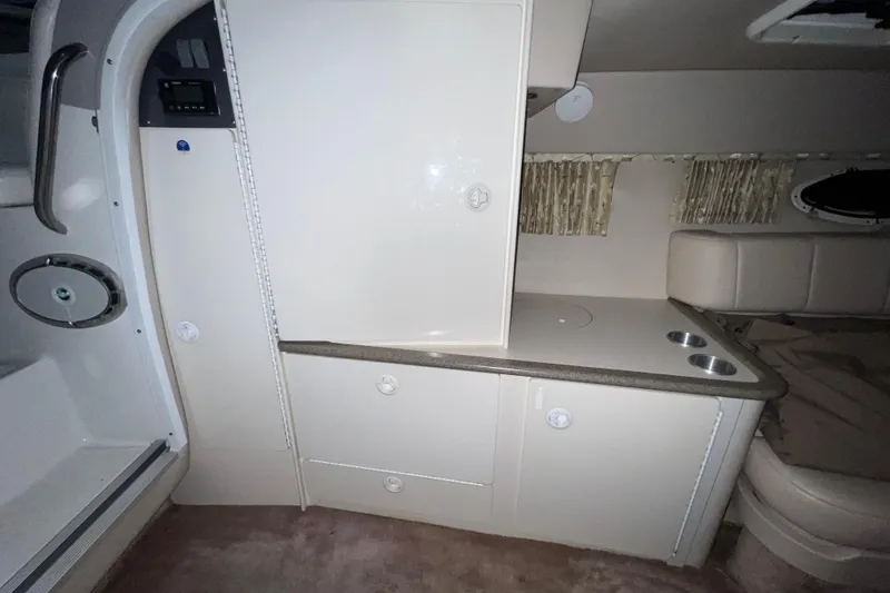 Slide: The Image of Interior of 1999 Formula 330 Sun Sport boat with beige seating and table. - 17