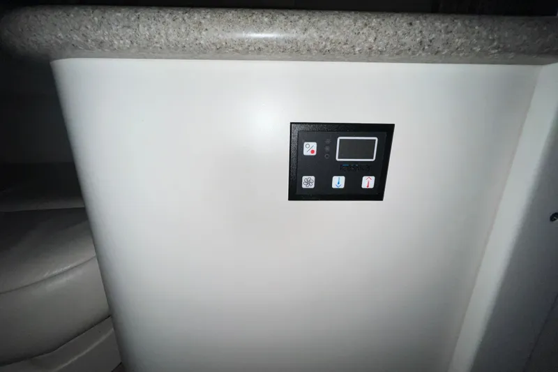 Slide: The Image of Interior of a 1999 Formula 330 Sun Sport boat with beige seating and table. - 18