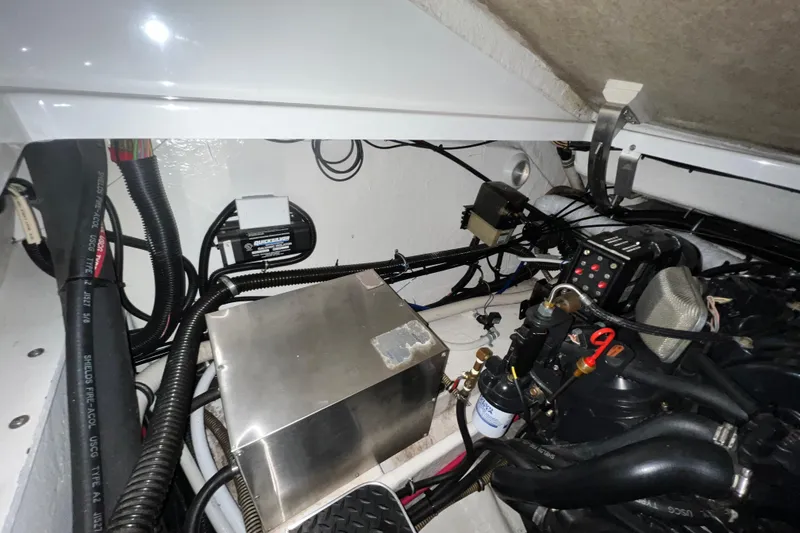 Slide: The Image of Twin engines in a 1999 Formula 330 Sun Sport boat, showcasing detailed mechanical components. - 21