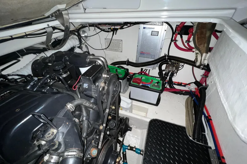 Slide: The Image of Engine compartment of a 1999 Formula 330 Sun Sport boat, showcasing mechanical components. - 22