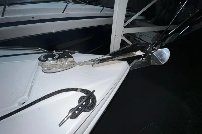 Slide: The Image of Engine compartment of a 1999 Formula 330 Sun Sport boat, showcasing mechanical components and wiring. - 24