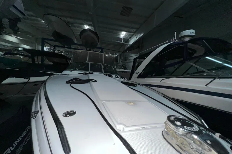 Slide: The Image of 1999 Formula 330 Sun Sport boat in indoor storage, showcasing sleek design and modern features. - 27