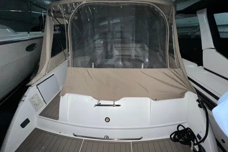 Slide: The Image of 1999 Formula 330 Sun Sport boat in indoor storage, featuring sleek design and dark hull. - 3