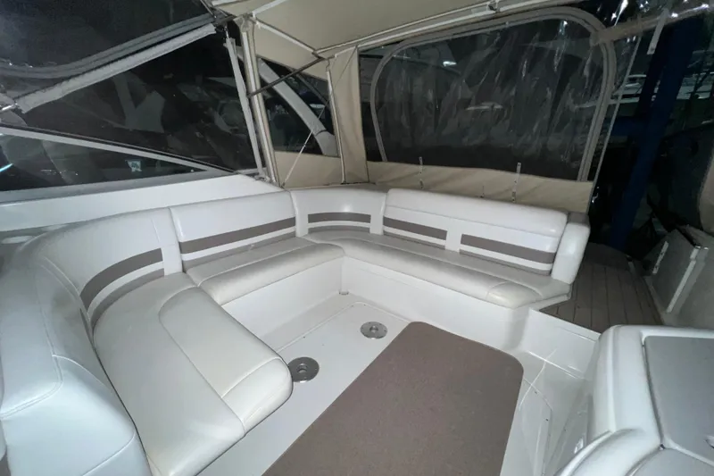 Slide: The Image of 1999 Formula 330 Sun Sport boat in storage, featuring a Mercury outboard motor. - 6