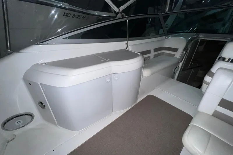 Slide: The Image of 1999 Formula 330 Sun Sport boat interior with white seating and dashboard. - 7