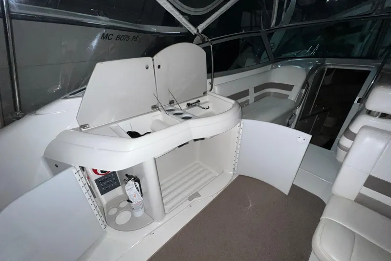 Slide: The Image of 1999 Formula 330 Sun Sport boat interior with white seating and canopy. - 8