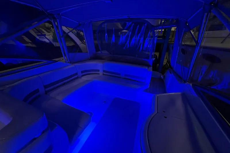 Slide: The Image of 1999 Formula 330 Sun Sport boat interior with white seating and storage compartments. - 9