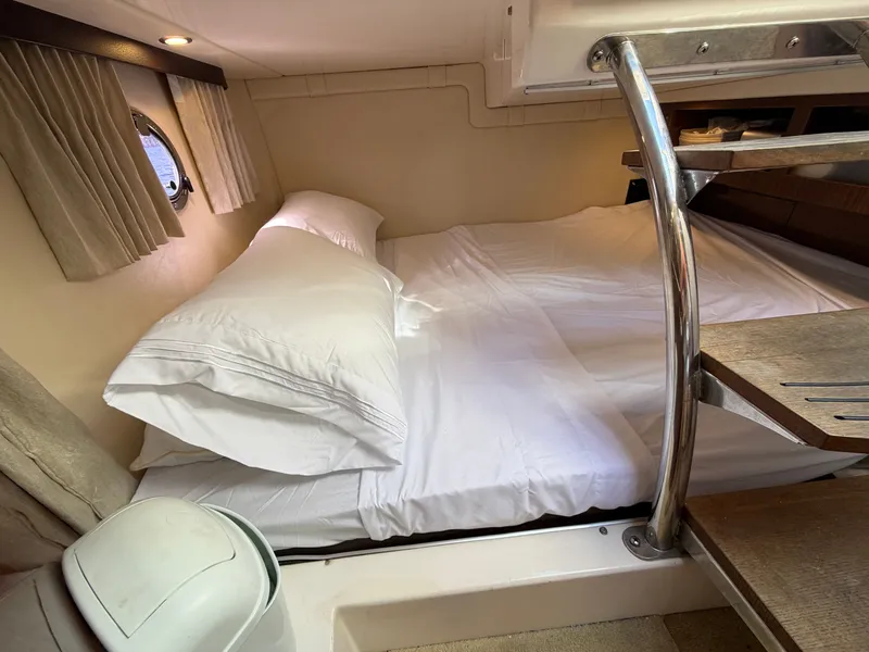 Slide: The Image of Interior of a 2015 Regal 28 Express with cozy bed. - 10