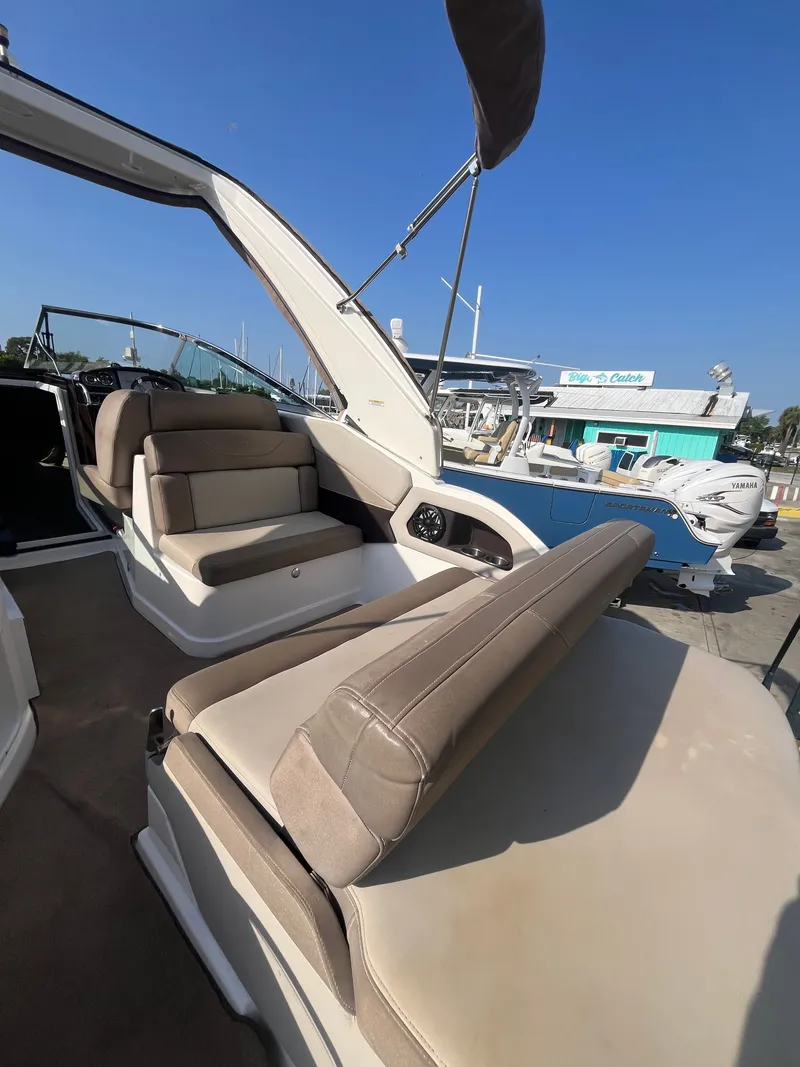 Slide: The Image of Interior of a 2015 Regal 28 Express boat with beige seating. - 18
