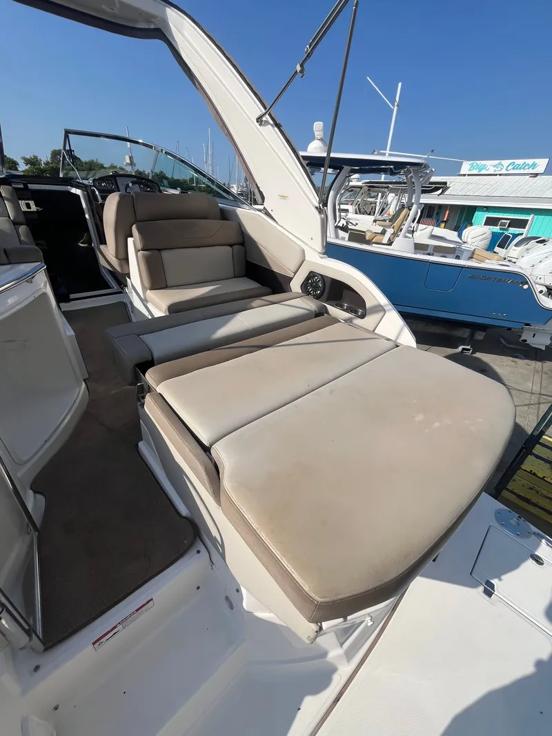 Slide: The Image of 2015 Regal 28 Express boat with comfortable seating area. - 19