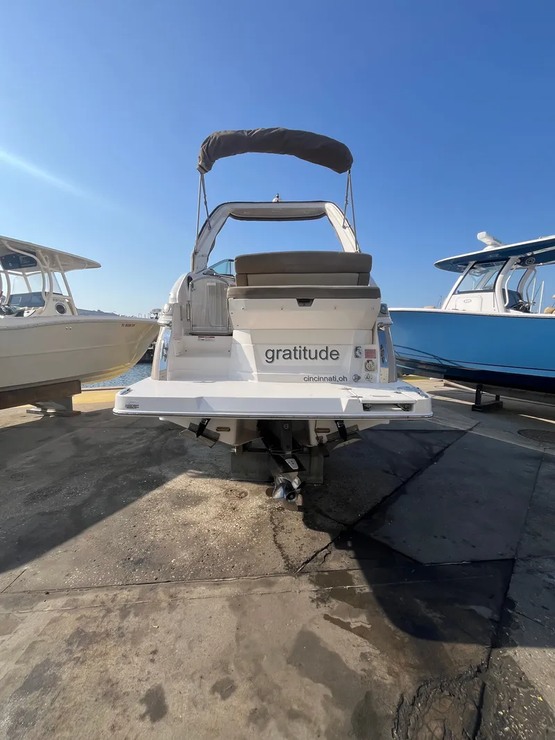 Slide: The Image of Rear view of a 2015 Regal 28 Express boat in harbor. - 2