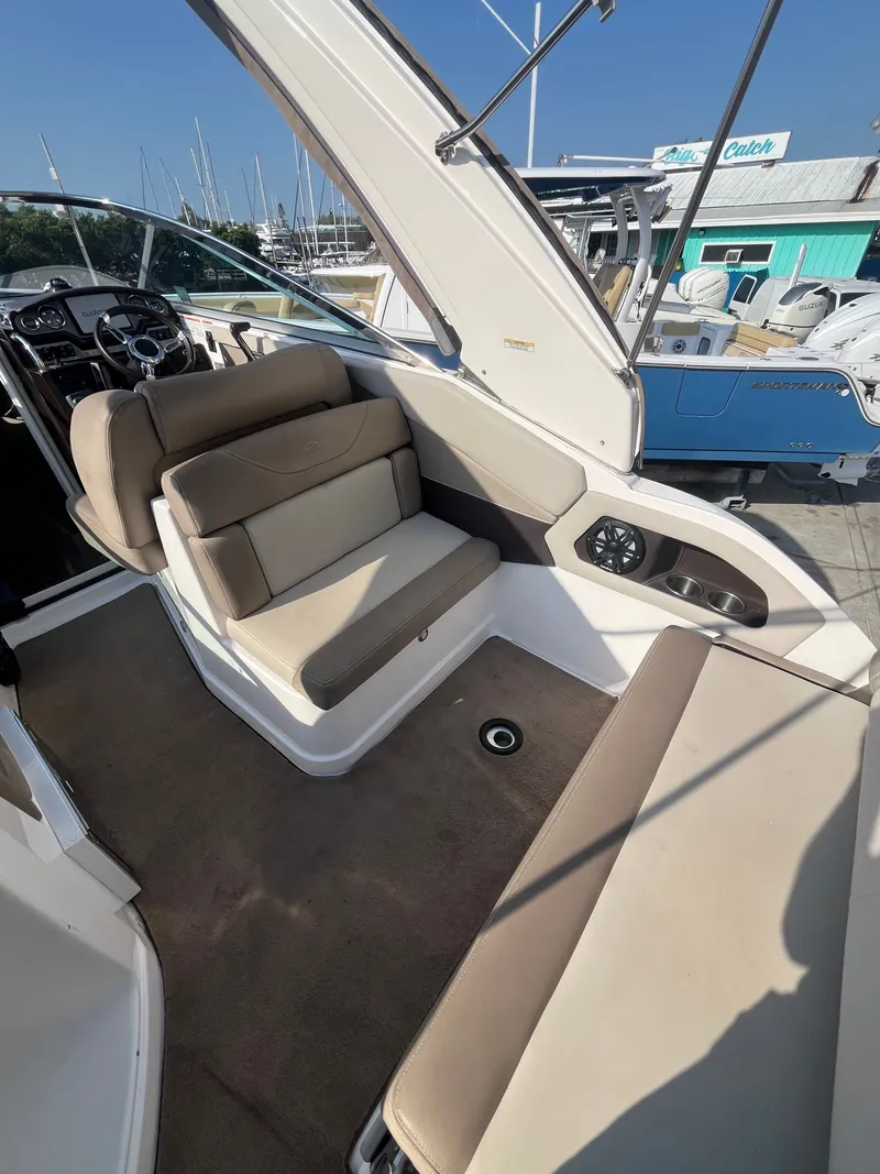 Slide: The Image of Interior of a 2015 Regal 28 Express boat with beige seating. - 21