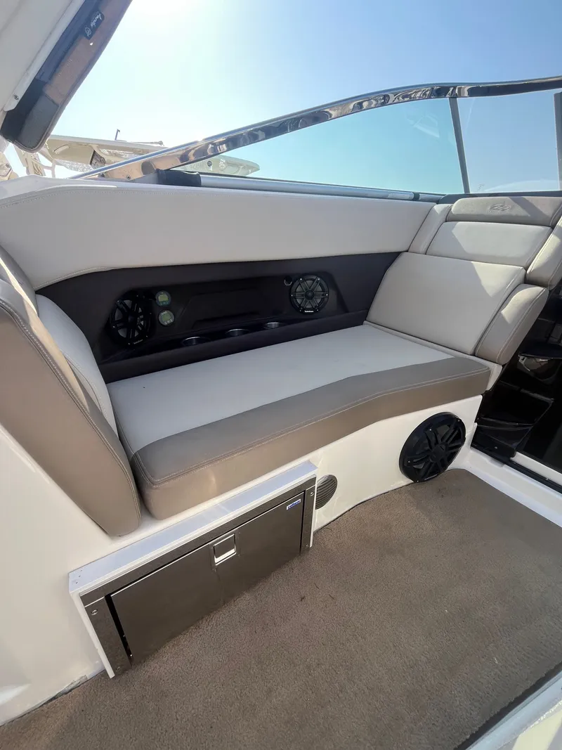 Slide: The Image of Interior of a 2015 Regal 28 Express boat with seating and speakers. - 23