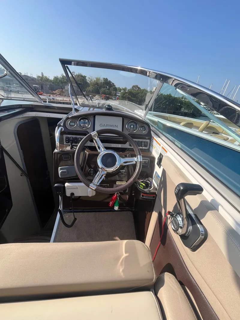 Slide: The Image of Interior view of a 2015 Regal 28 Express boat with Garmin controls. - 29