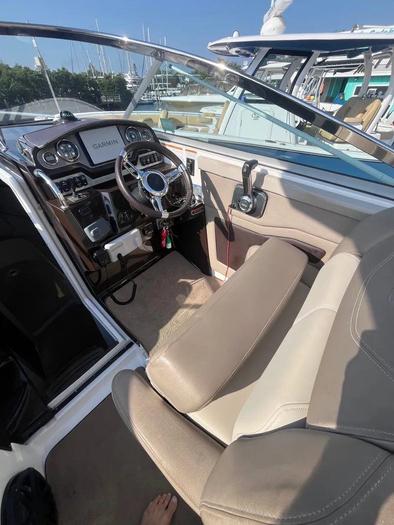 Slide: The Image of Interior of a 2015 Regal 28 Express boat with helm console. - 31