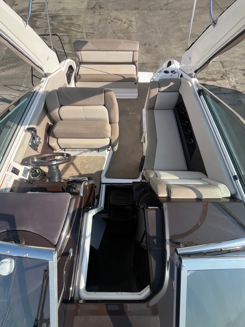 Slide: The Image of Interior of a 2015 Regal 28 Express boat with beige seating. - 36