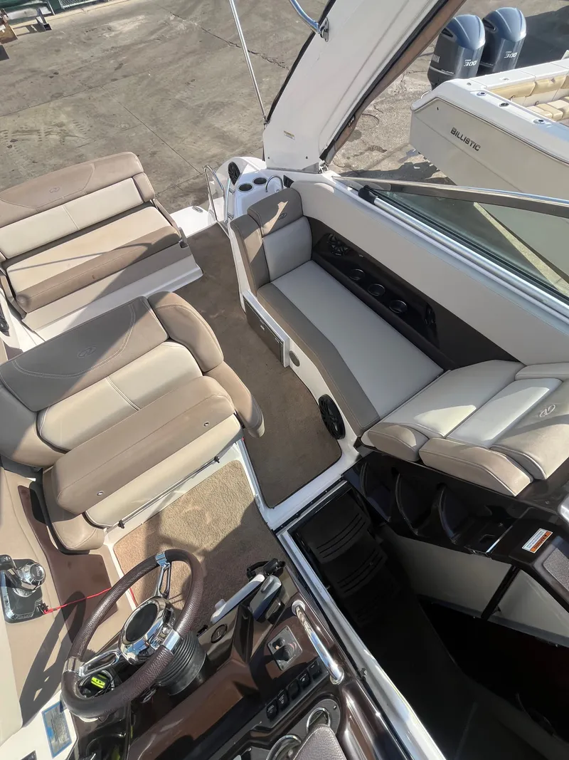 Slide: The Image of Interior of a 2015 Regal 28 Express boat with beige seating. - 37