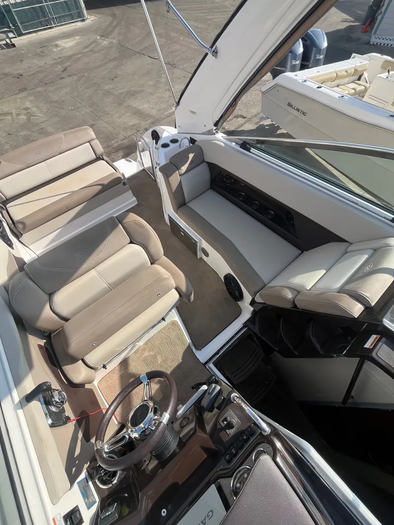 Slide: The Image of Interior of a 2015 Regal 28 Express boat with beige seating. - 39