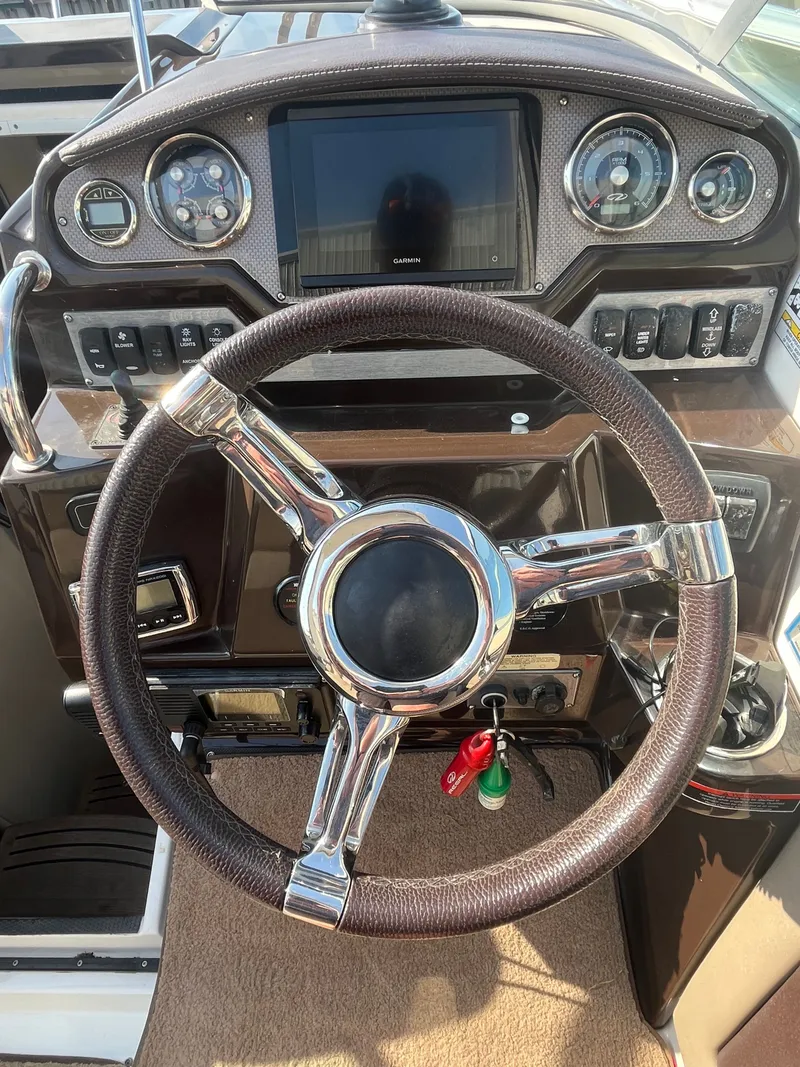 Slide: The Image of Steering console of a 2015 Regal 28 Express boat. - 42