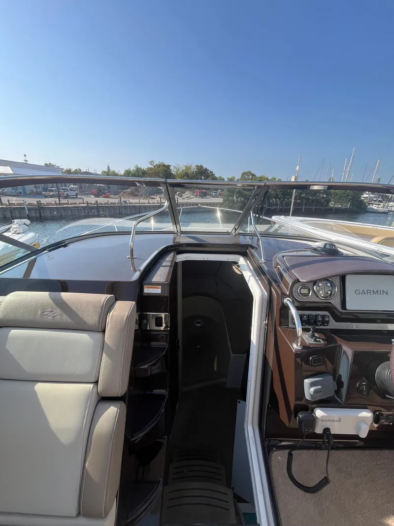 Slide: The Image of Interior view of a 2015 Regal 28 Express boat with Garmin navigation. - 44