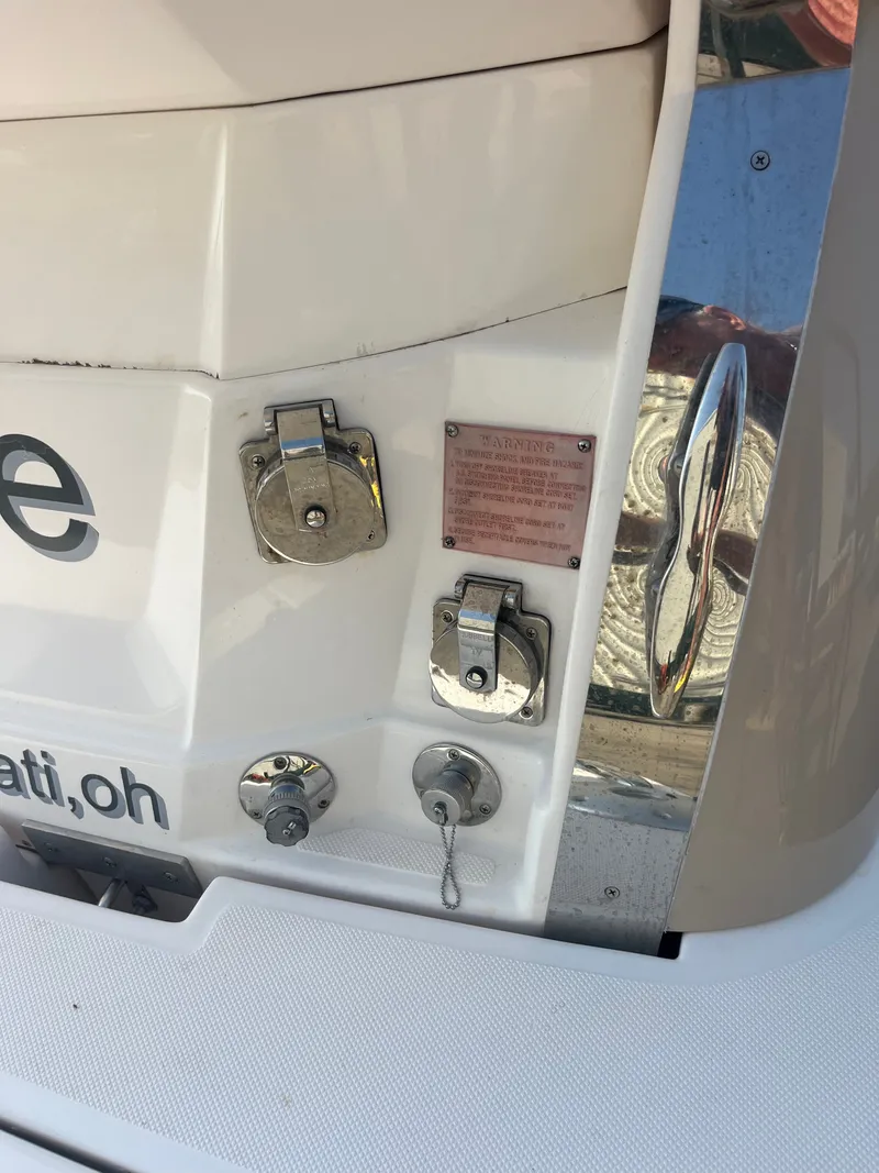 Slide: The Image of Rear view of a 2015 Regal 28 Express boat with connectors and warning plaque. - 46