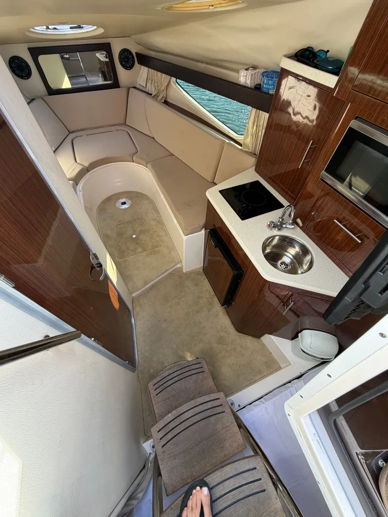Slide: The Image of Interior of a 2015 Regal 28 Express yacht with kitchen and seating area. - 5