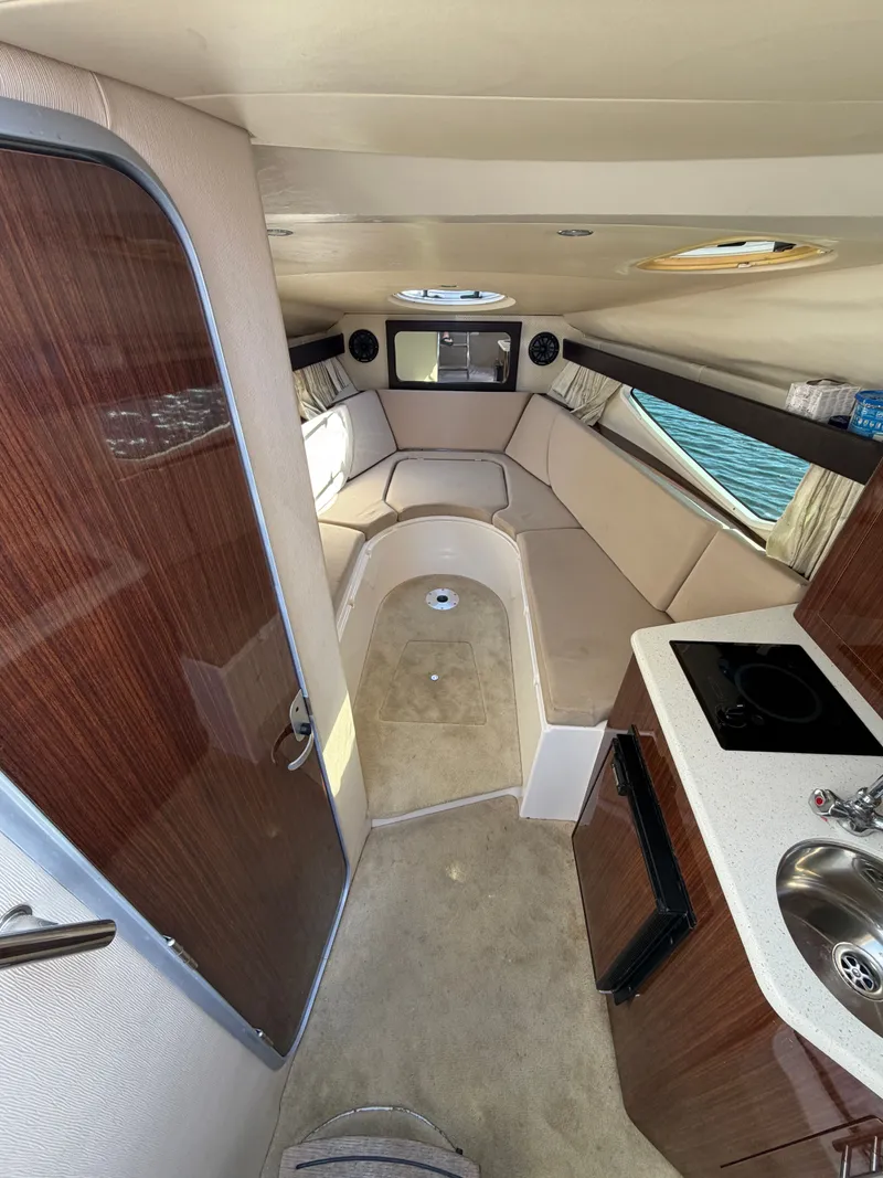 Slide: The Image of Interior of a 2015 Regal 28 Express yacht with kitchenette and seating area. - 6