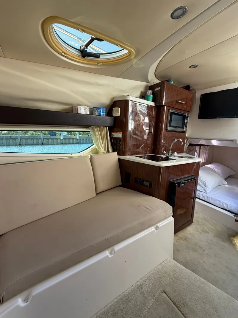 Slide: The Image of Interior of a 2015 Regal 28 Express with kitchen and sleeping area. - 9