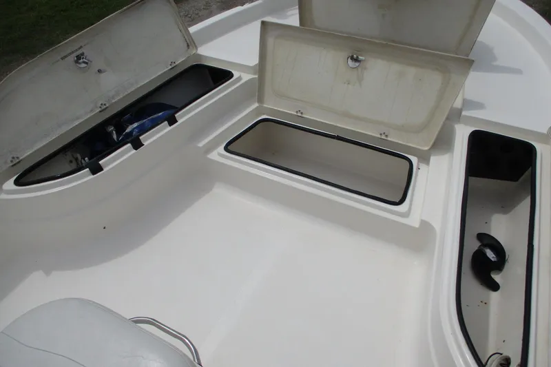 Slide: The Image of 2005 NauticStar 2200 NauticBay boat storage compartments open on deck. - 11