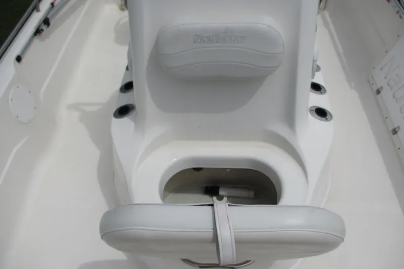 Slide: The Image of 2005 NauticStar 2200 NauticBay boat interior with seating and storage compartment. - 16