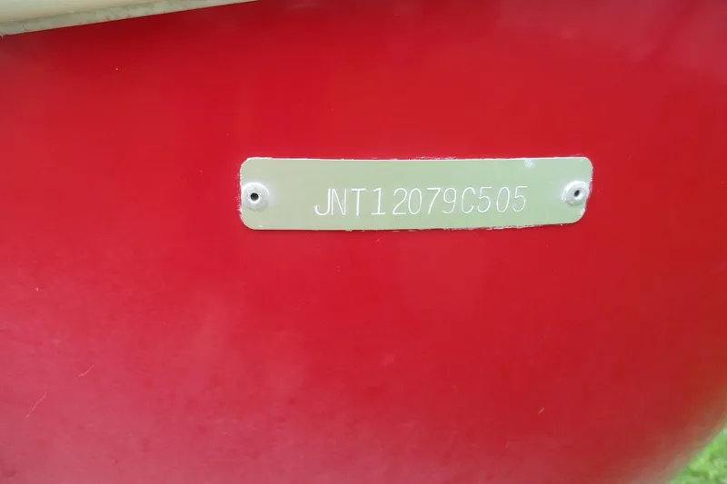 Slide: The Image of Red 2005 NauticStar 2200 NauticBay boat with visible hull identification number. - 19