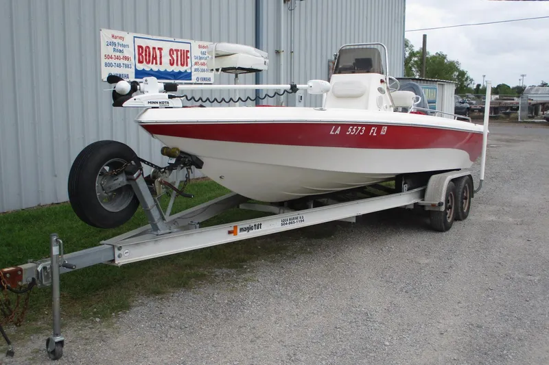 Slide: The Image of 2005 NauticStar 2200 NauticBay boat on trailer, parked outside a building. - 2